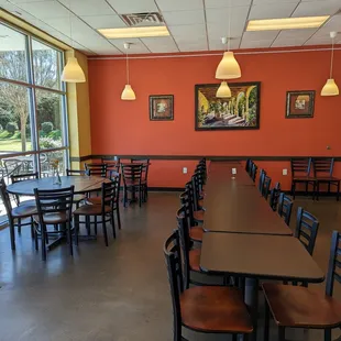 a dining area with tables and chairs