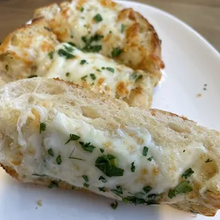 two slices of bread with cheese and herbs