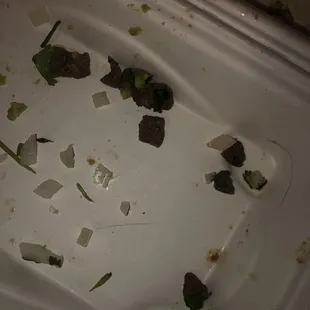 a dirty sink with a lot of food left on it