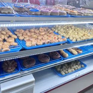 a variety of donuts in a display case