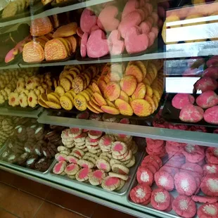 a variety of donuts in a display case