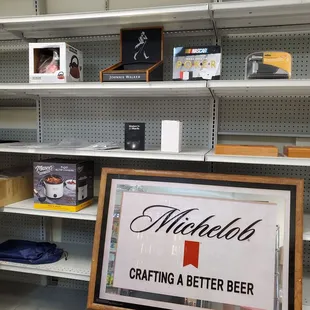 In the far back of Mario's Store are different signs, Banners and shelves For Sale on Clearance.  8/30/2024