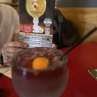 a person holding up a menu