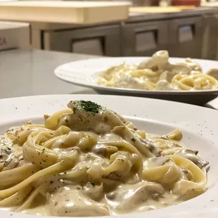 two plates of pasta with mushrooms