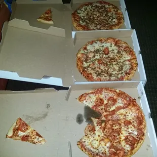 a pizza in a box with a slice taken out of it