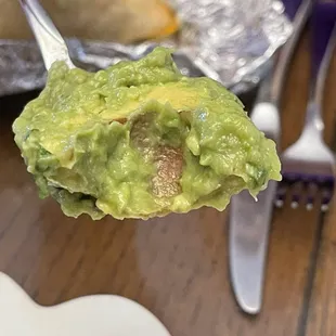 Chunk of avocado seed in guacamole.