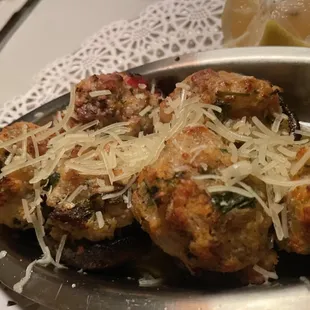 a plate of meatballs with grated parmesan cheese