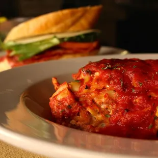 a plate of lasagna and a sandwich