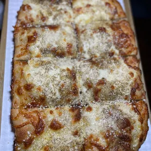 a square pizza on a wooden table