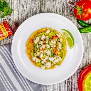 a plate of fish tacos with guacamole