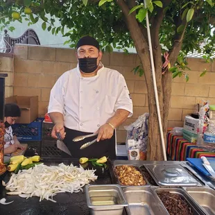 a chef preparing food on a grill