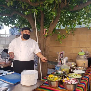 a man in a face mask preparing food