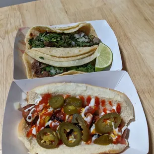 two hot dogs with toppings