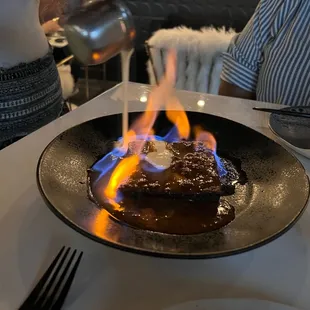 Flaming sticky toffee pudding