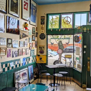 tables and chairs in front of a window