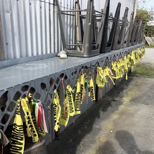 a row of chairs with yellow ribbons tied to them