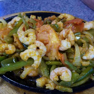 The fajitas is large and is teeming with small shrimp