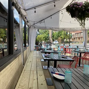 a patio with tables and chairs