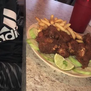 a plate of fried chicken and french fries