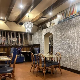 a dining area with tables and chairs