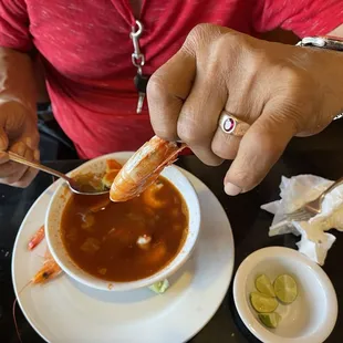 a man eating a bowl of soup