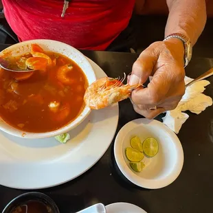 a person eating a bowl of soup