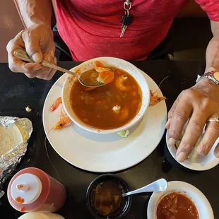a man eating a bowl of soup
