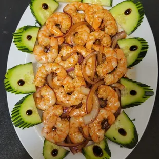 a plate of shrimp and cucumbers