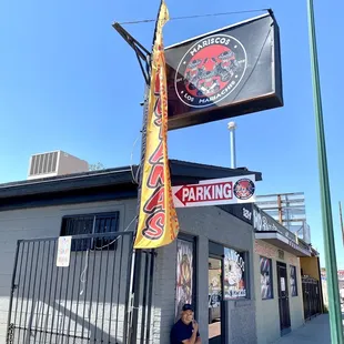 a man sitting on a bench in front of a building