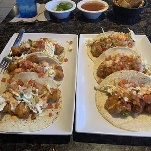two plates of tacos on a table
