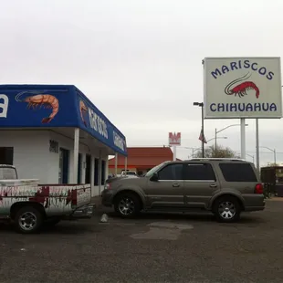 two vehicles parked in front of a restaurant
