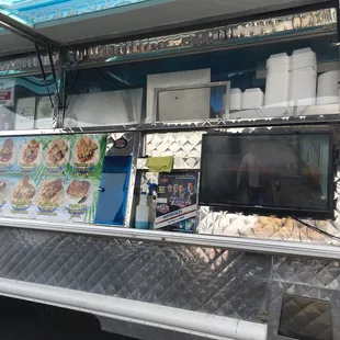 a food truck with a flat screen tv