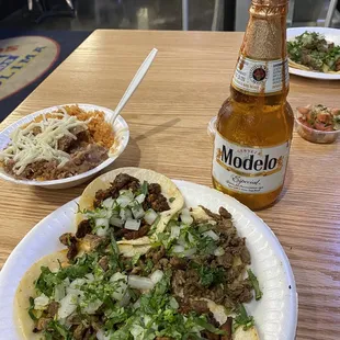 2 asada 2 al pastor tacos, rice and beans with a modelo