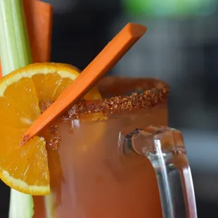 a bloody drink garnished with a slice of orange