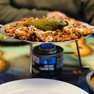 "discadas" pork, shrimp, beef, onions, tomatoes, topped with white cheese over flame.