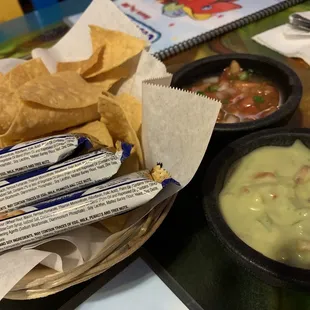 Chips and crackers and salsa and guacamole