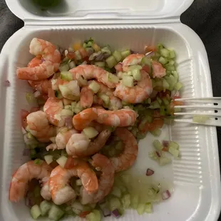 a shrimp salad in a styrofoam container