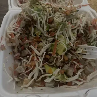a salad in a styrofoam container