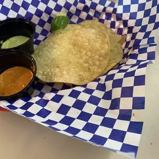 Appetizer tostadas and hot sauce.