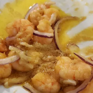 a plate of food with shrimp and onions