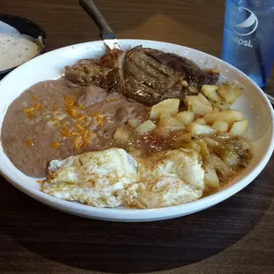 Steak n eggs with beans, potatoes n green chili. About one third of steak was fat. Overall the meal was good...
