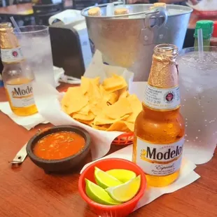 a bottle of model mexican beer and a bowl of tortillas