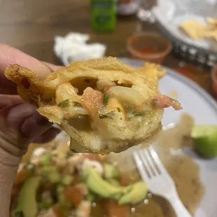 a hand holding a piece of food