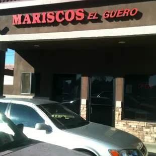 a car parked in front of a restaurant