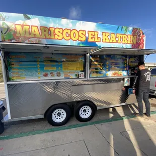 a man standing in front of a food truck