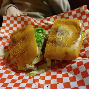 a sandwich on a red and white checkered paper