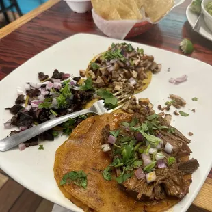 Three tacos overflowing with meat. The birria is AMAZING.