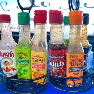 Many different kind of hot sauces on the table (10/23)