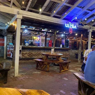 people sitting at tables in a restaurant