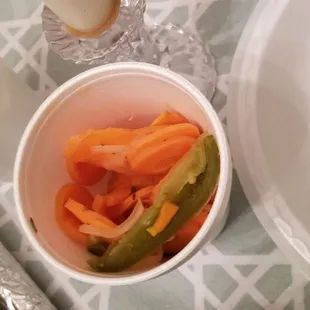 a bowl of carrots, pickles, and yogurt